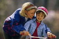 Mom Teaching Child To Ride Bike